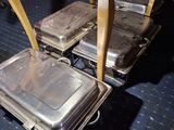 several trays of food sit on top of a table on a blue carpet