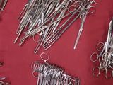 many pairs of scissors on a red surface