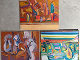 four paintings of different colors are displayed on a wall