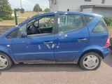une petite voiture bleue garée dans un parking