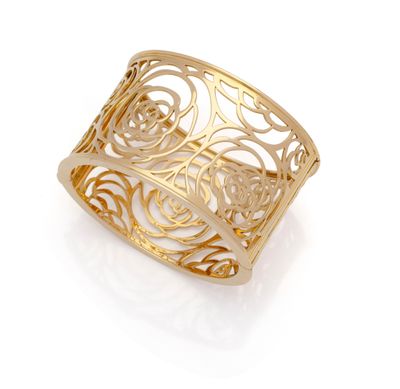 a close up of a gold ring on a white background