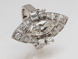 a close up of a diamond ring on a white surface