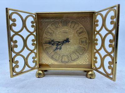 une horloge en or posée sur une table
