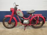 a red motorcycle that is parked in a garage