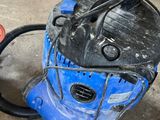 a blue and black machine that is sitting on the ground