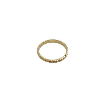 a close up of a gold ring on a white background