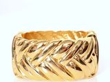 a close up of a gold ring on a white surface