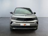 the front view of a silver suv parked in a white room