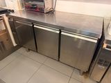 stainless steel counter top in a commercial kitchen with a toaster oven