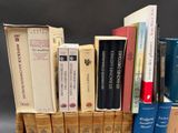 a lot of books that are stacked on top of each other