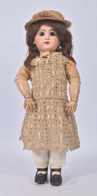 an image of a doll with a hat and dress on