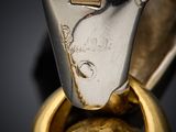 close up of a gold and silver ring with a diamond on it