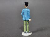 a figurine of a man in a blue jacket and green pants