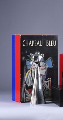 two books and a silver vase on a table