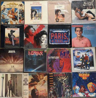 many movie posters on the wall of a room