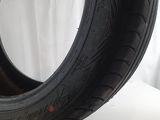 a close up of a tire on a table with a white background