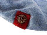 a blue hat with a red patch on it
