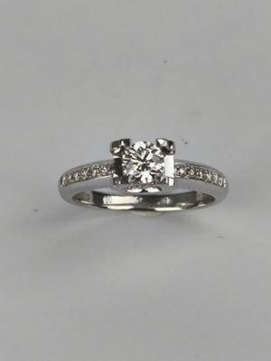 a close up of a diamond ring on a white background