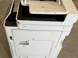 a printer sitting on top of a cabinet in a warehouse