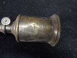 a small brass object on a black surface