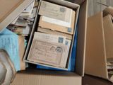 a box full of old letters and envelopes sitting on the floor