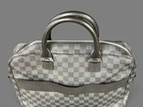 a white and grey checkered bag with a metal handle