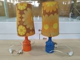 two lamps that are sitting on a table next to each other