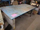 a table that has a sign on it in the middle of a room