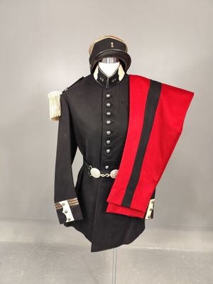 a black and red uniform on a mannequin stand