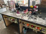 a workbench with a bunch of craft supplies on it