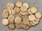 a pile of old coins sitting on top of a table