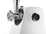 a close up of a meat grinder on a white surface