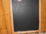 a chalk board in the corner of a room