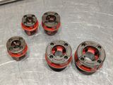 four red and black wheels are sitting on a metal surface