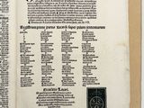 an open book with a black and white image of a cross on it
