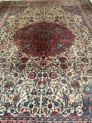 an antique persian rug with a large medallion design on the center
