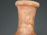 a brown vase that is sitting on a table
