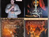 three books on a table, one of which has a picture of a man holding a sword and the other of which has a picture of a man holding a sword