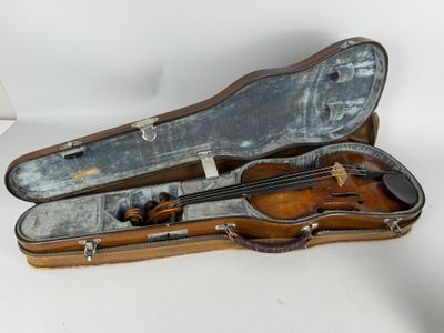 a violin in a case sitting on a white surface