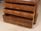 a brown chest of drawers with a clock on top