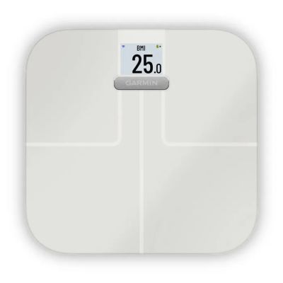 a white bathroom scale with a clock on top of it