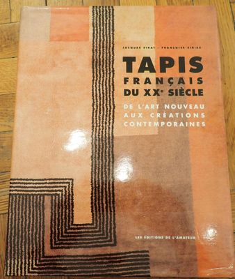 an image of a book on a wooden floor with a black and orange design