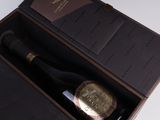 a bottle of wine in a box on a table