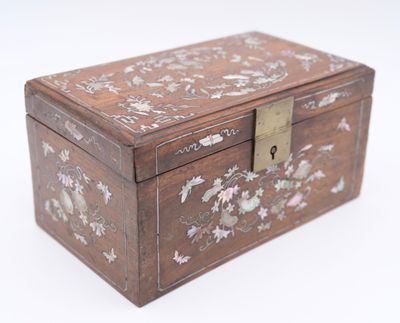 a small wooden box with a floral design on it