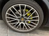 the tire of a car with a yellow brake sticker on it