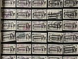 a black and white photo of a wall with stamps