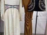 two dresses that are on display on a rack