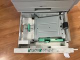 an overhead view of a printer sitting on top of a hard wood floor