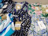 many different types of scarves laid out on a table
