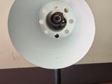 a lamp that is sitting on a table next to a wall